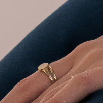 round signet ring on person